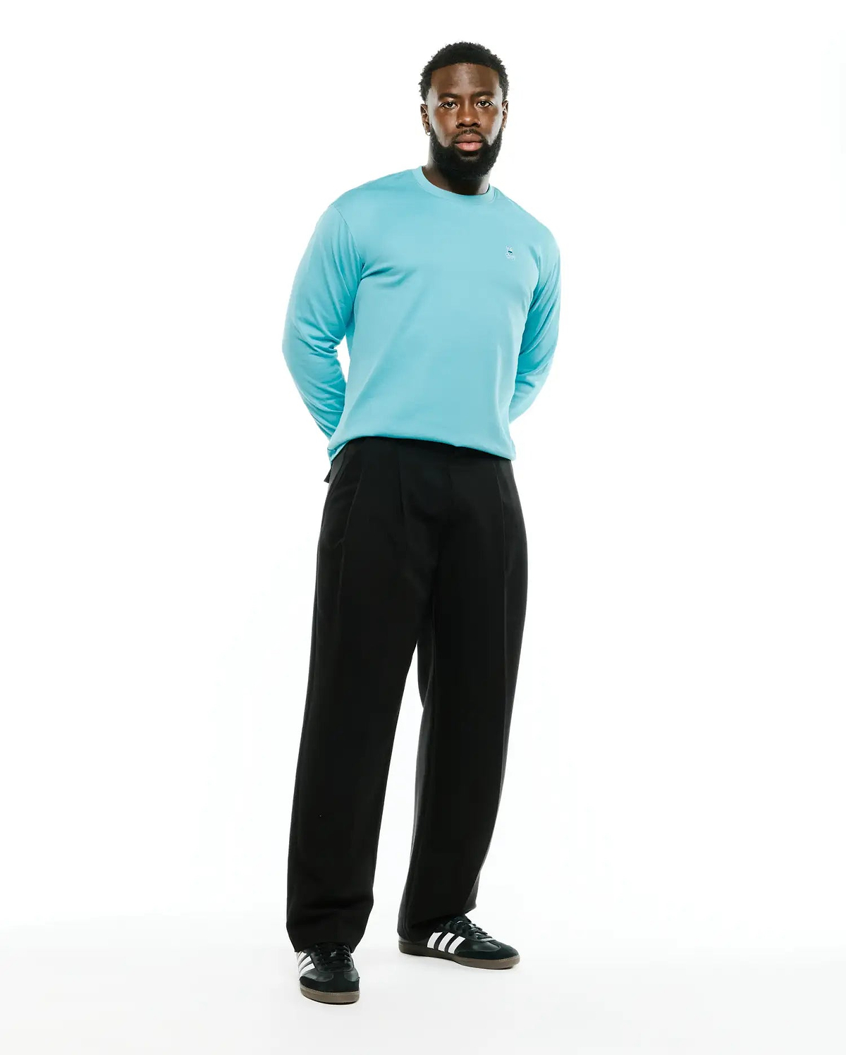 Men's Norman Longsleeve Oversized Tee in aqua blue, featuring a smooth jersey knit fabric and a small embroidered Psycho Bunny skull logo on the left chest. (4)