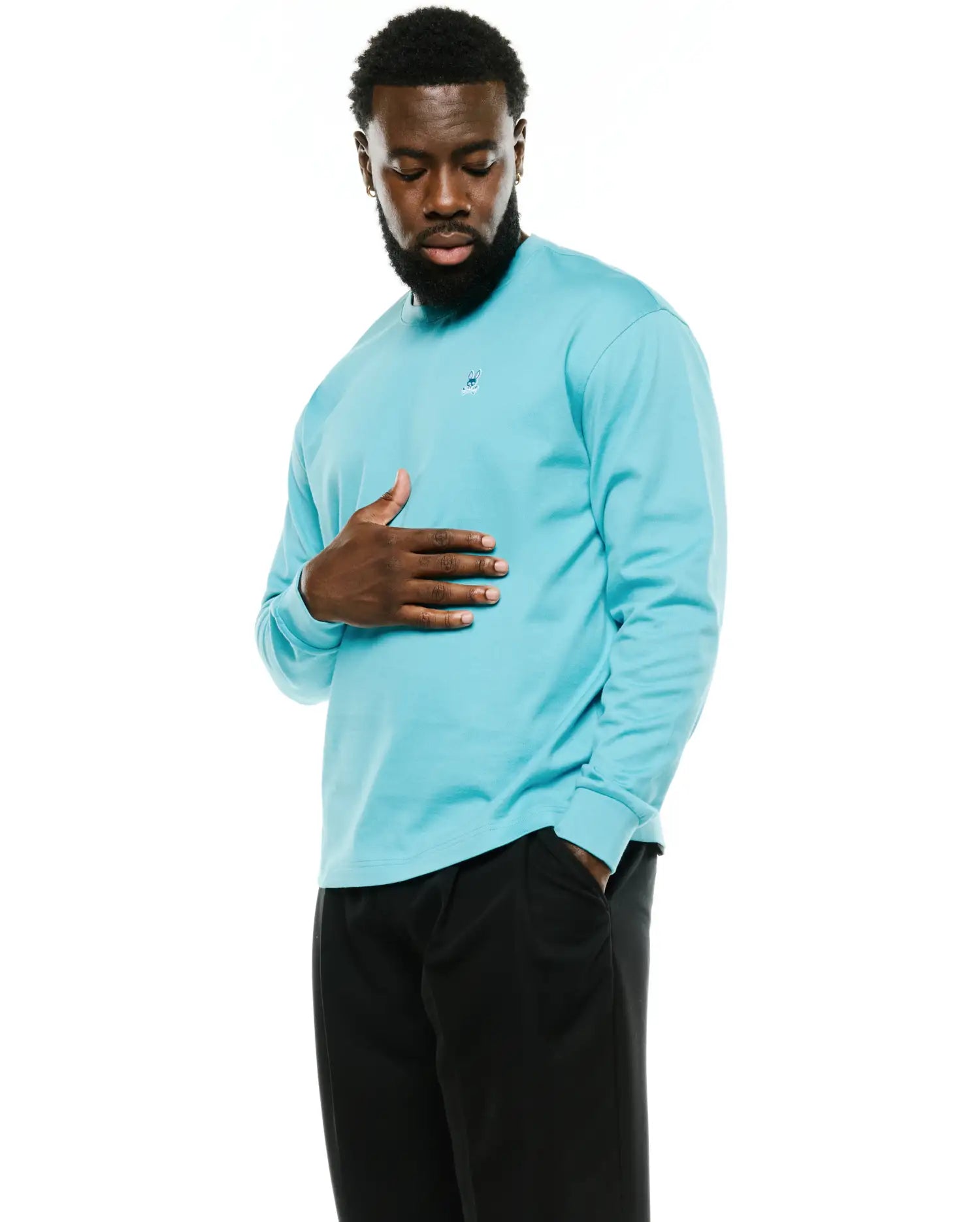 Men's Norman Longsleeve Oversized Tee in aqua blue, featuring a smooth jersey knit fabric and a small embroidered Psycho Bunny skull logo on the left chest. (1)