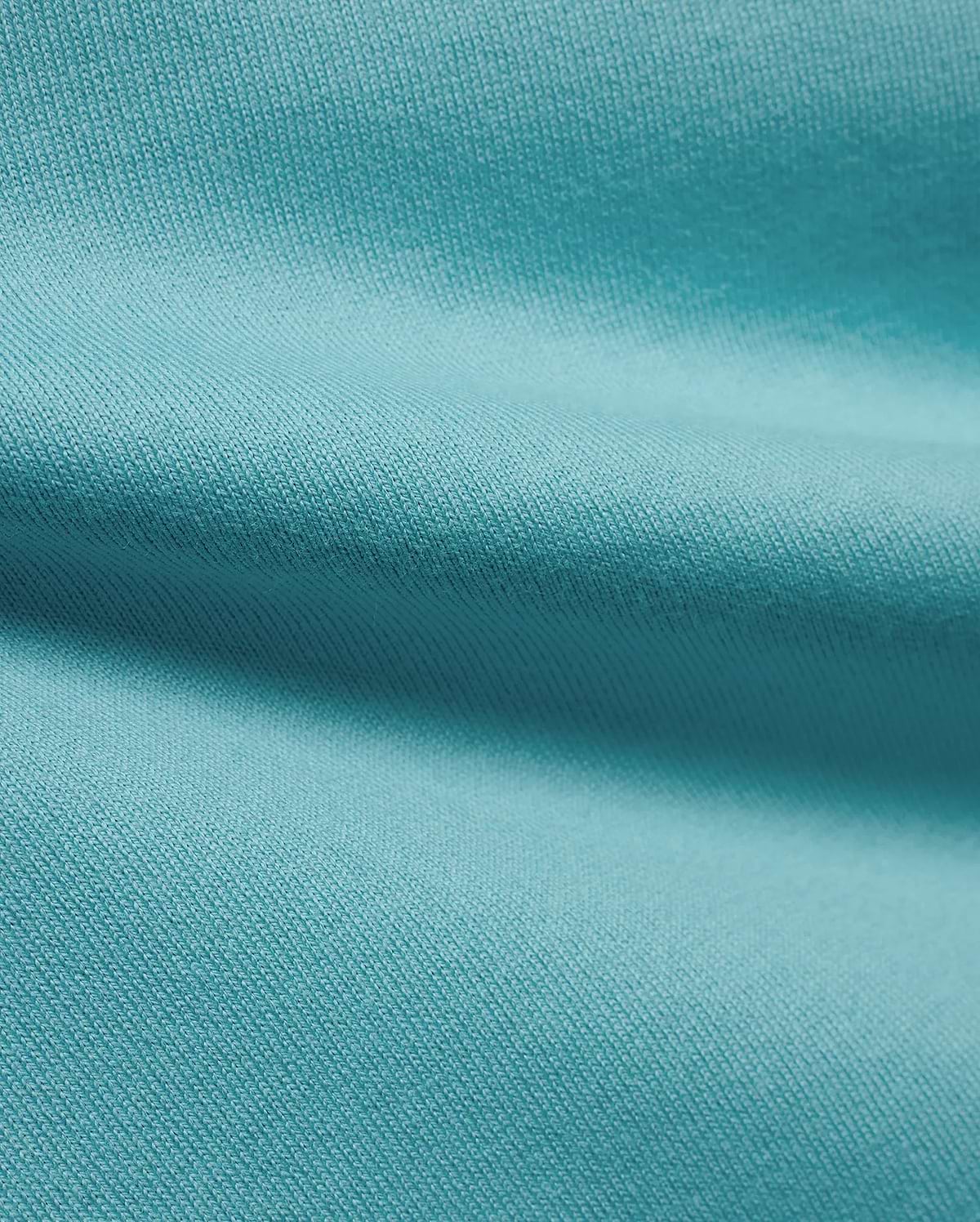 Men's Norman Longsleeve Oversized Tee in a vibrant aqua hue, highlighting the premium, soft jersey knit fabric with a smooth, comfortable texture and subtle draping. (6)