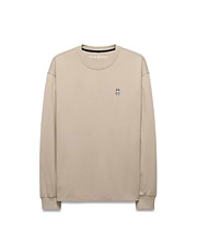 Mens Norman Long Sleeve Relaxed Fit Tee in beige, crafted from soft jersey knit, featuring a small, iconic embroidered Psycho Bunny skull logo on the left chest.