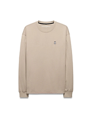 Mens Norman Long Sleeve Relaxed Fit Tee in beige, crafted from soft jersey knit, featuring a small, iconic embroidered Psycho Bunny skull logo on the left chest.