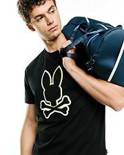 Mens Bruno Graphic Tee, black classic fit jersey knit t-shirt featuring a large central Psycho Bunny skull logo with white fill and neon yellow outline.
