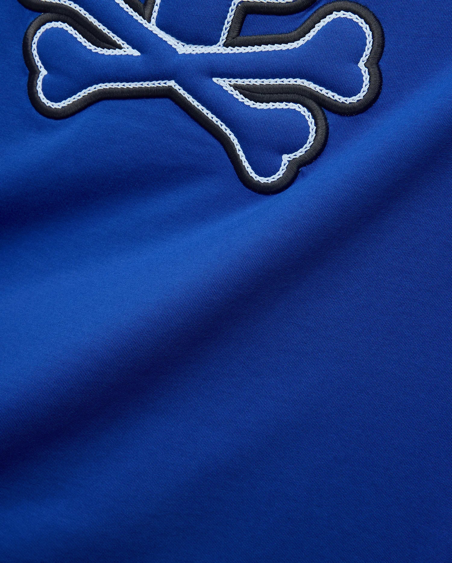 Royal blue Mens Bruno Graphic Tee in soft jersey, featuring a large embroidered Psycho Bunny skull logo with black outline and intricate white chain stitching.