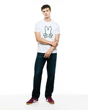 Mens Bruno Graphic Tee, a classic fit white jersey t-shirt featuring a prominent, centered green outline Psycho Bunny skull and crossbones logo graphic on the chest.