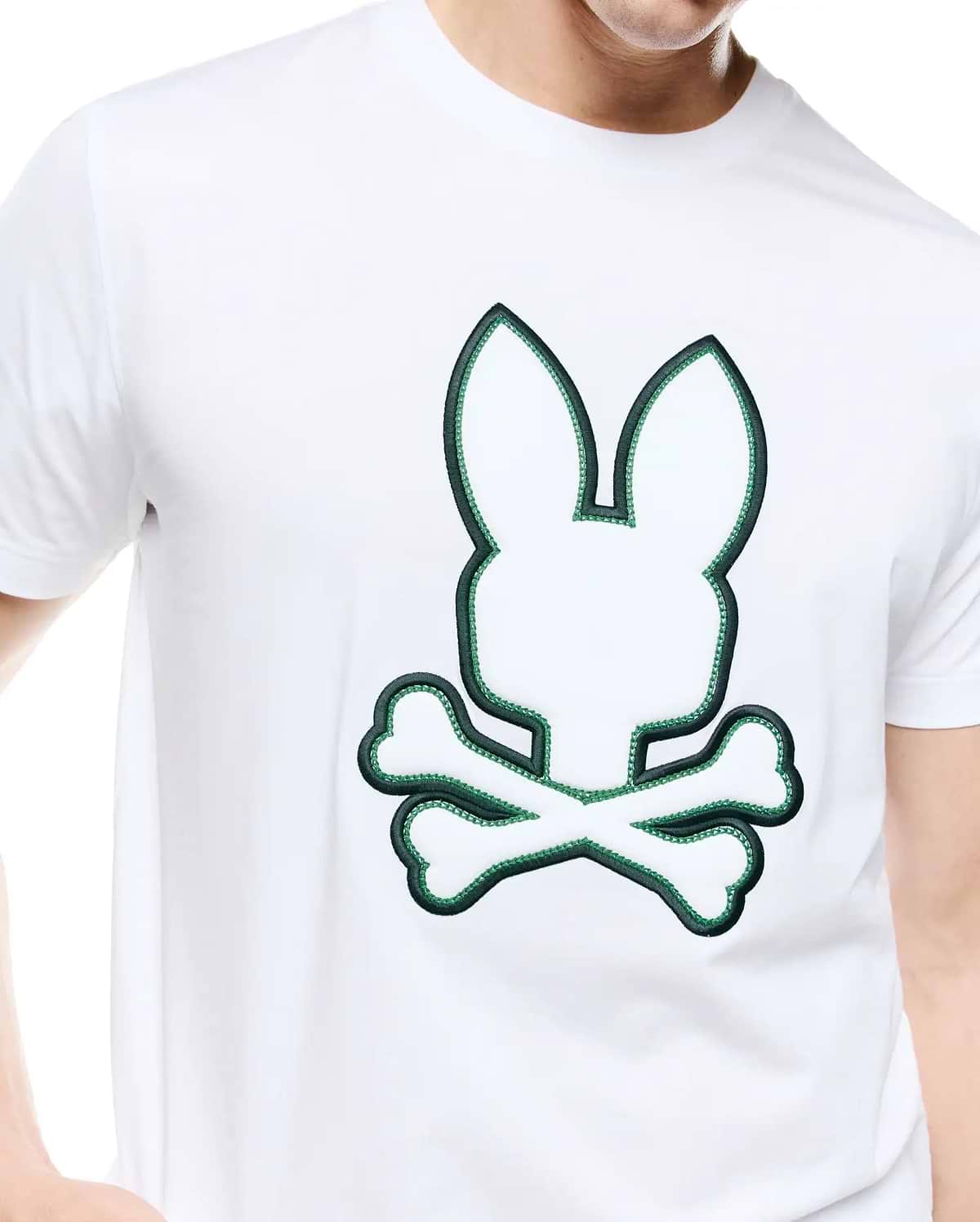 Mens Bruno Graphic Tee: White classic fit jersey t-shirt featuring a large, central embroidered Psycho Bunny skull logo with dark green outline and bright green inner stitching.