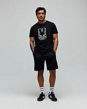 Mens Keon Embroidered Graphic Tee. Black classic-fit jersey t-shirt with a large white embroidered Psycho Bunny skull logo graphic and text on the chest, complemented by black relaxed shorts. (3)