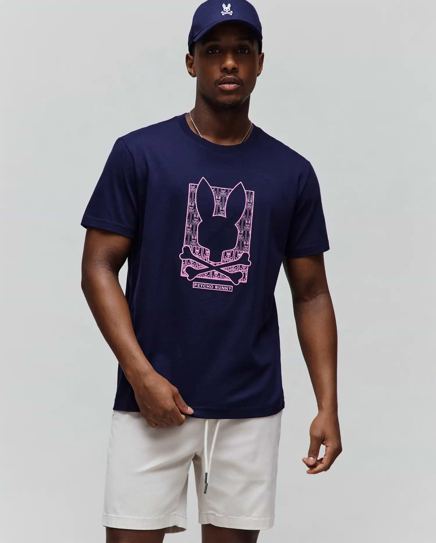 Mens Keon Embroidered Graphic Tee, a navy classic fit jersey knit t-shirt featuring a large central pink embroidered graphic of the iconic Psycho Bunny skull logo with intricate patterns. (2)