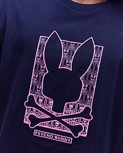 Navy classic fit jersey T-shirt with a large, central pink embroidered Psycho Bunny skull logo graphic, filled with a repeating mini bunny skull and crossbones pattern. Mens Keon Embroidered Graphic Tee. (3)