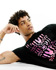 Mens Lewis Graphic Tee, black classic fit jersey t-shirt featuring a large pink gradient graphic print of a skeleton rib cage formed by iconic bunny skulls and bones on the front.