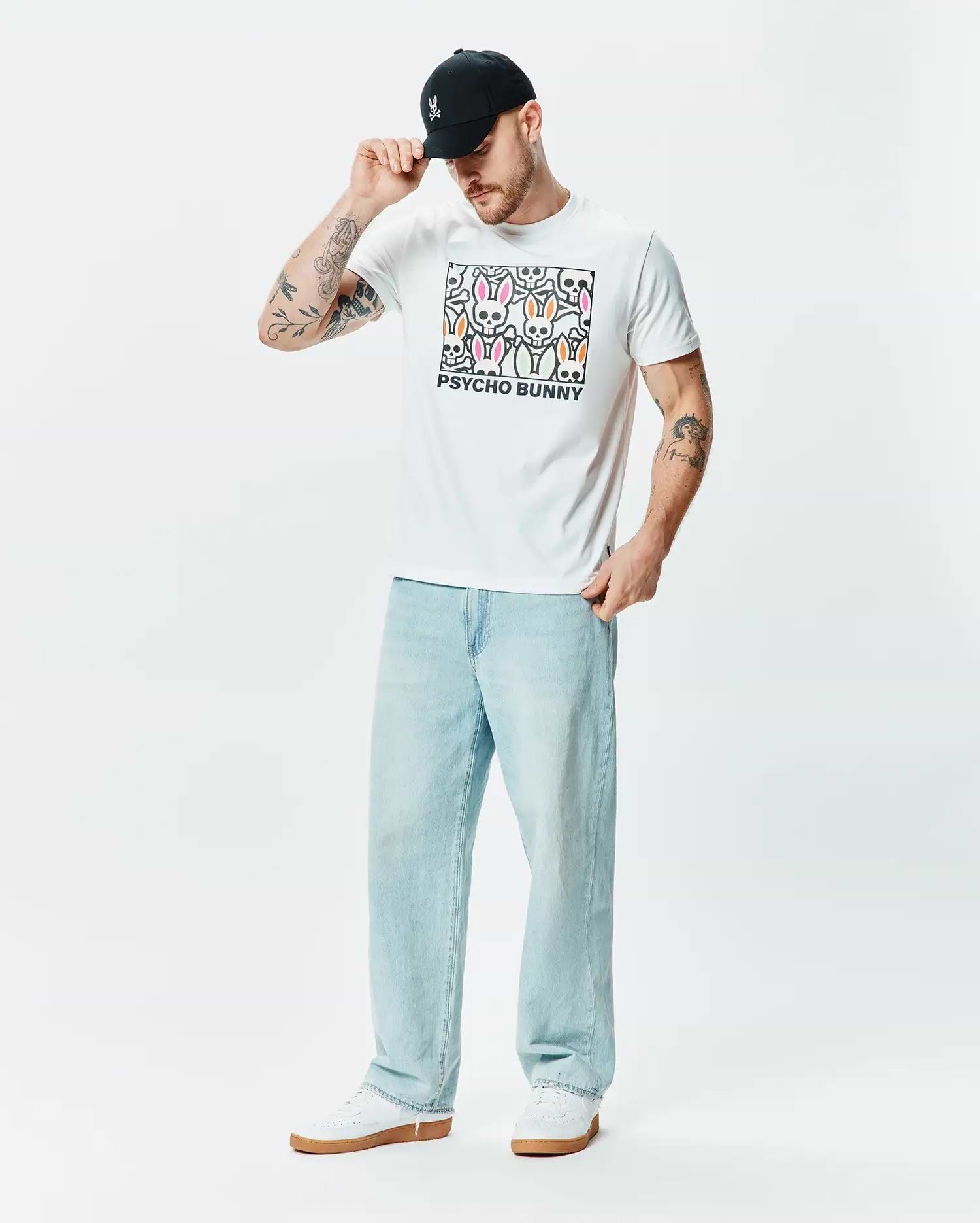 White classic fit jersey T-shirt, Mens Byron Graphic Tee, featuring a large central chest graphic of colorful Psycho Bunny skull logos in pink, green, and orange with black outlines and PSYCHO BUNNY text. (5)