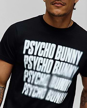 Mens Lawrence Graphic Tee, black classic fit jersey knit t-shirt featuring a large, central white blurred repeating PSYCHO BUNNY text graphic print. (3)