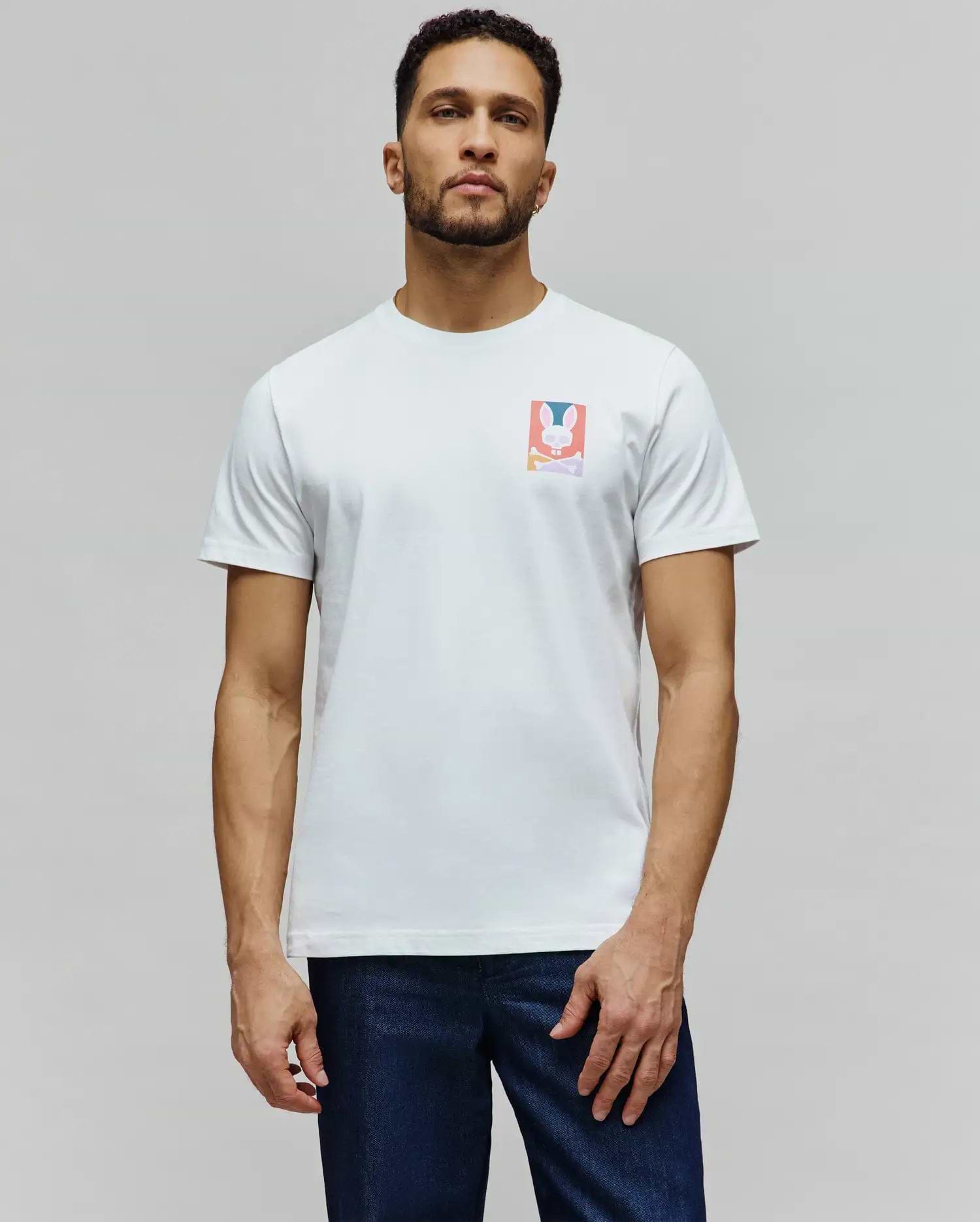 Mens Raphael Back Graphic Tee, a classic fit white jersey t-shirt featuring a small, colorful rectangular chest graphic of the iconic Psycho Bunny skull and crossbones logo in pink, blue, orange, and purple. (4)