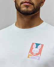White Mens Raphael Back Graphic Tee, a classic fit jersey knit, featuring a small, vibrant chest graphic of the iconic Psycho Bunny skull logo in coral, teal, pink, and purple hues. (5)