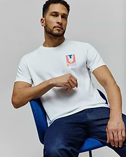 Mens Raphael Back Graphic Tee, a white classic fit jersey t-shirt featuring a small, vibrant Psycho Bunny skull and crossbones graphic on the left chest. (6)