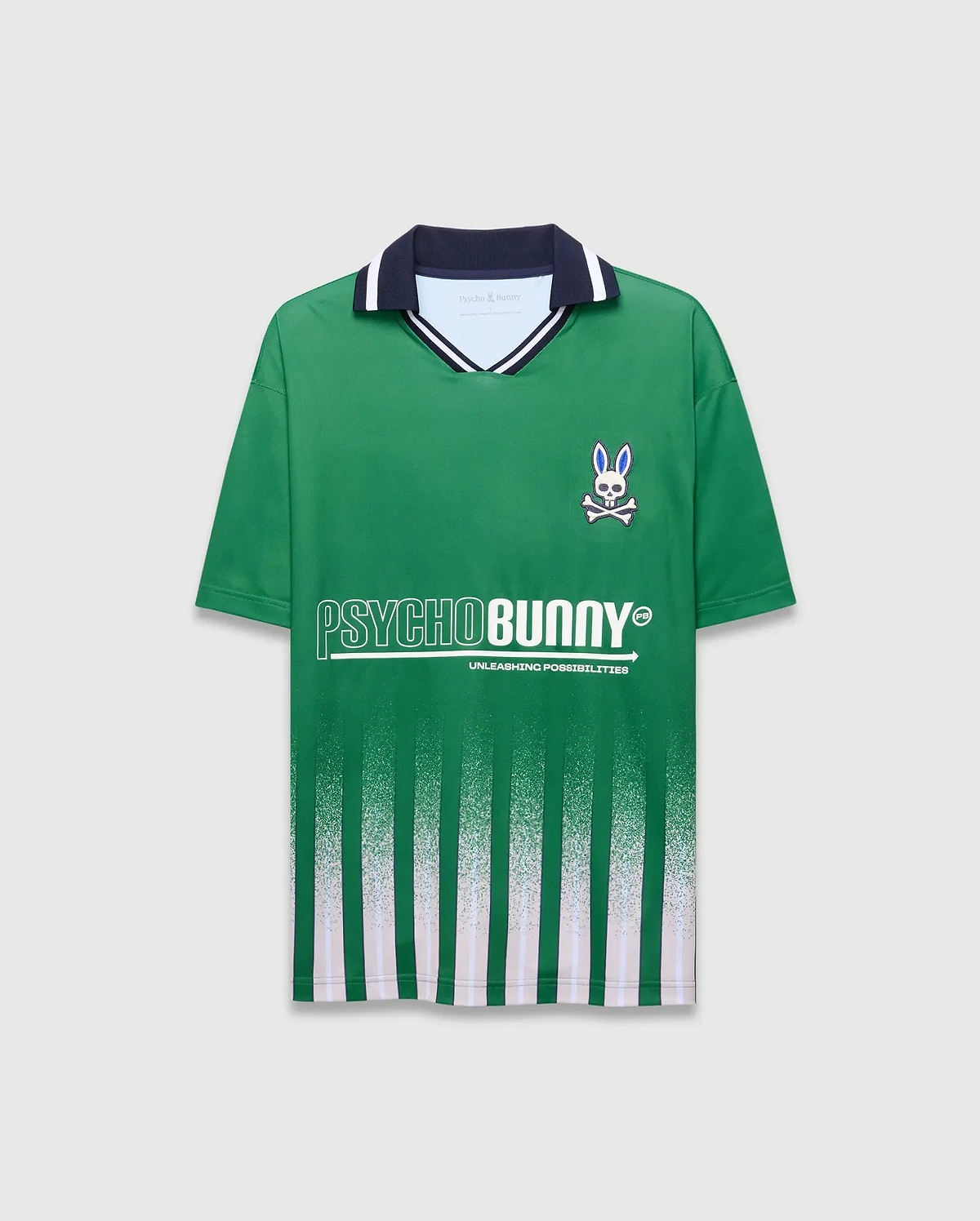 Mens Camden Oversized Soccer Jersey in green jersey knit, featuring a navy and white striped collar, small embroidered blue-eyed bunny skull logo on left chest, large white PSYCHOBUNNY graphic, and fading vertical green and white stripes. (5)