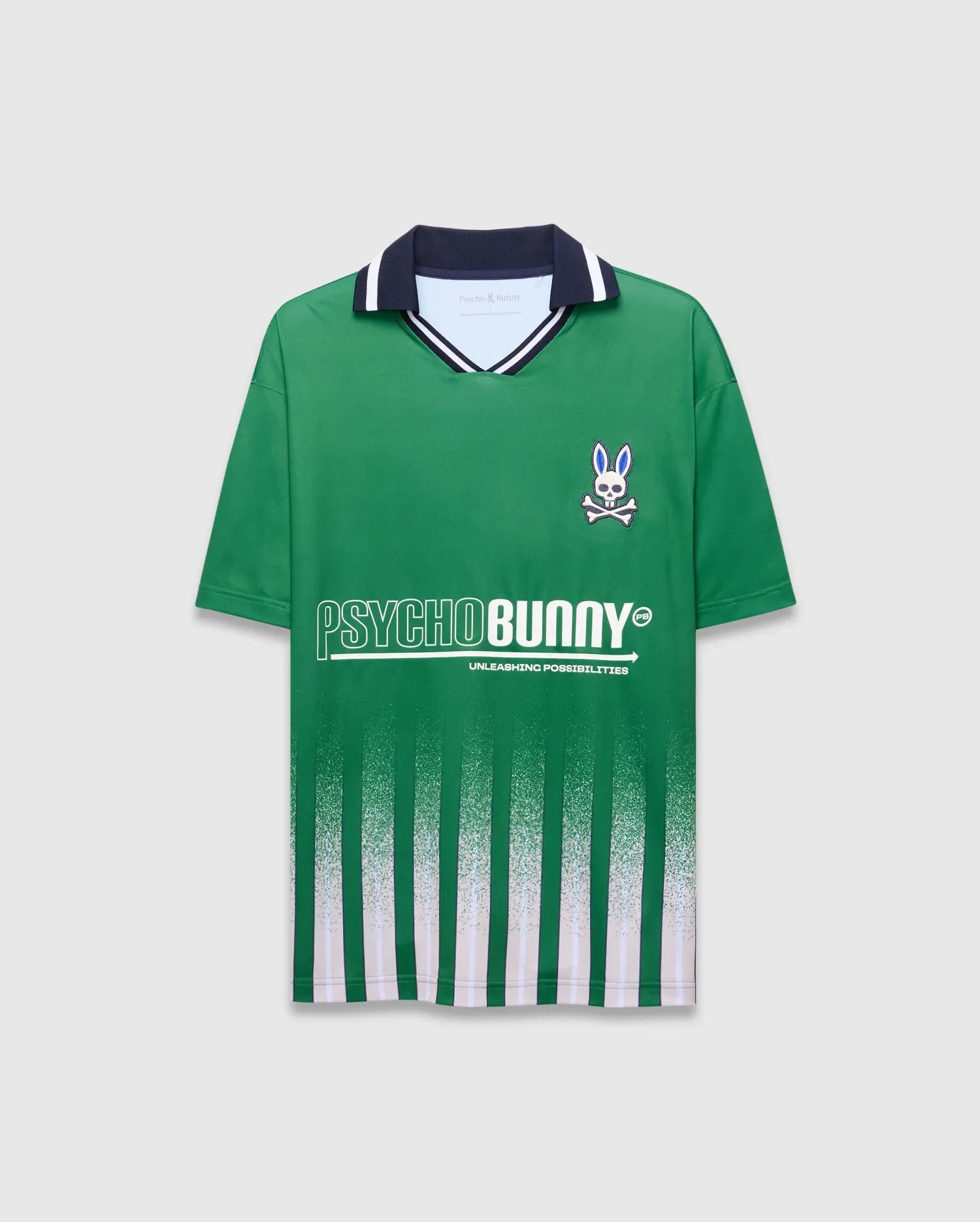 Mens Camden Oversized Soccer Jersey in green jersey knit, featuring a navy and white striped collar, small embroidered blue-eyed bunny skull logo on left chest, large white PSYCHOBUNNY graphic, and fading vertical green and white stripes. (5)
