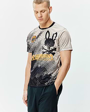 Mens Joshua Soccer Tee with a black and beige geometric pattern, large black Psycho Bunny skull and crossbones graphic, yellow brand text, and a small embroidered patch logo on the sleeve. Smooth jersey, classic fit. (1)