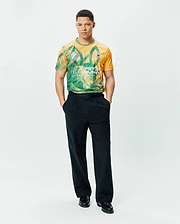 Mens Joshua Soccer Tee in gold and green geometric pattern, featuring a large PSYCHO BUNNY graphic and small blue bunny skull logo on the left chest, classic fit performance jersey. (5)