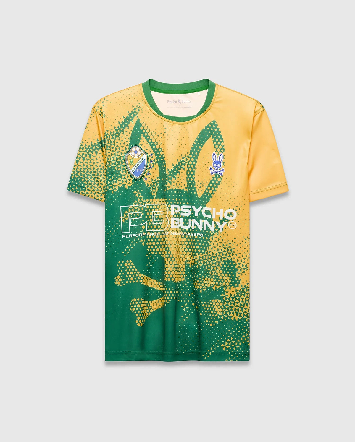 Vibrant yellow and green Mens Joshua Soccer Tee featuring a large pixelated bunny skull graphic, left chest Psycho Bunny FC crest, right chest blue bunny skull, and central Psycho Bunny text on smooth performance jersey fabric. (6)
