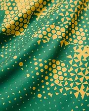 Joshua Soccer Tee featuring a bold green base with a vibrant yellow geometric pattern, transitioning from dense hexagons to scattered triangles on a smooth performance fabric. (7)