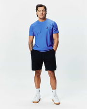 MENS TAYLOR PIQUE TEE in vibrant blue, featuring a classic fit and small black embroidered Psycho Bunny skull logo on the left chest, paired with black jersey shorts.