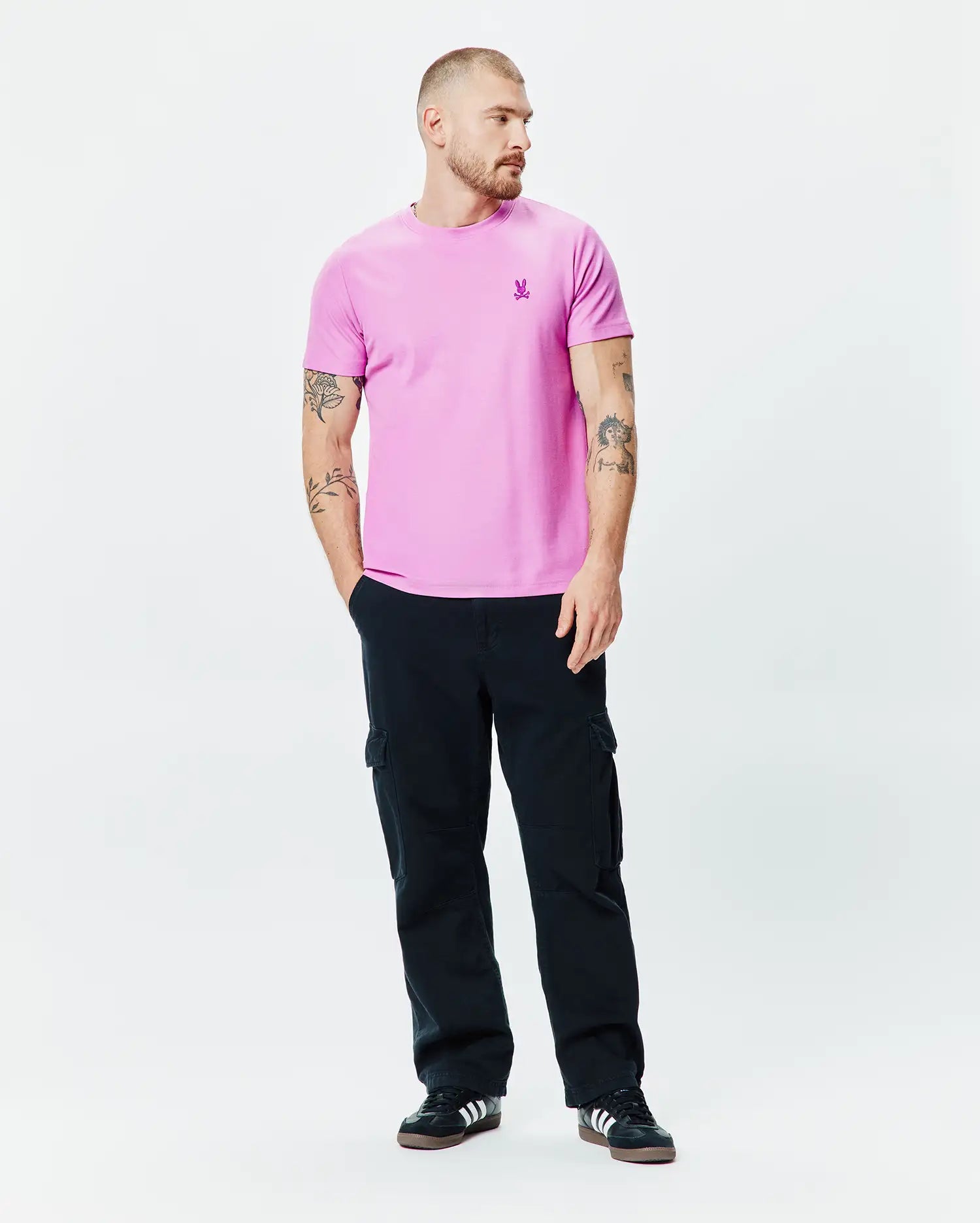 Mens Taylor Pique Tee in vibrant pink, featuring a classic fit and a small, embroidered purple Psycho Bunny skull logo on the left chest.