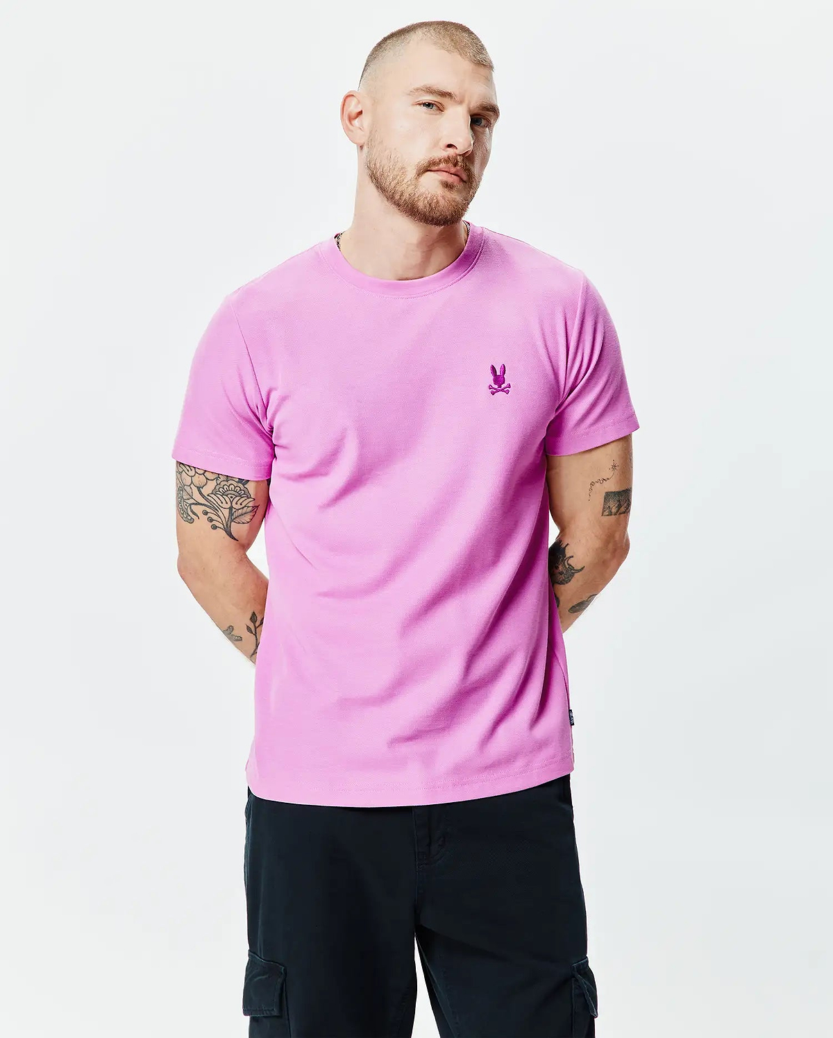 MENS TAYLOR PIQUE TEE in vibrant pink, featuring a classic fit and a small, embroidered magenta Psycho Bunny skull logo on the left chest.