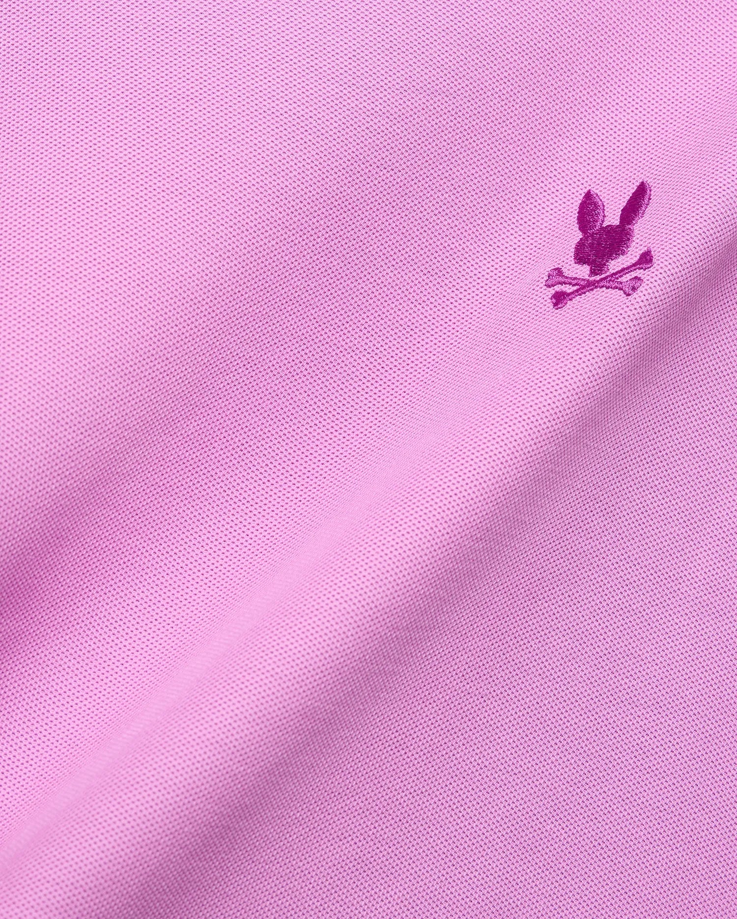 MENS TAYLOR PIQUE TEE in vibrant pink pique knit, featuring a small, intricately embroidered magenta Psycho Bunny skull logo on the chest, embodying refined streetwear style.
