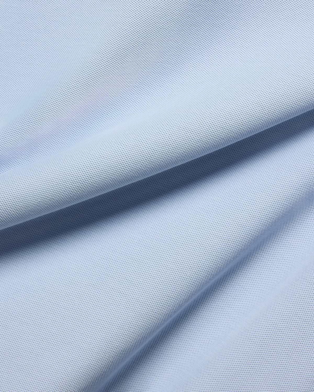 MENS TAYLOR PIQUE TEE in a serene light blue, highlighting the premium, breathable pique fabric with its distinctive textured weave and soft, flowing folds.