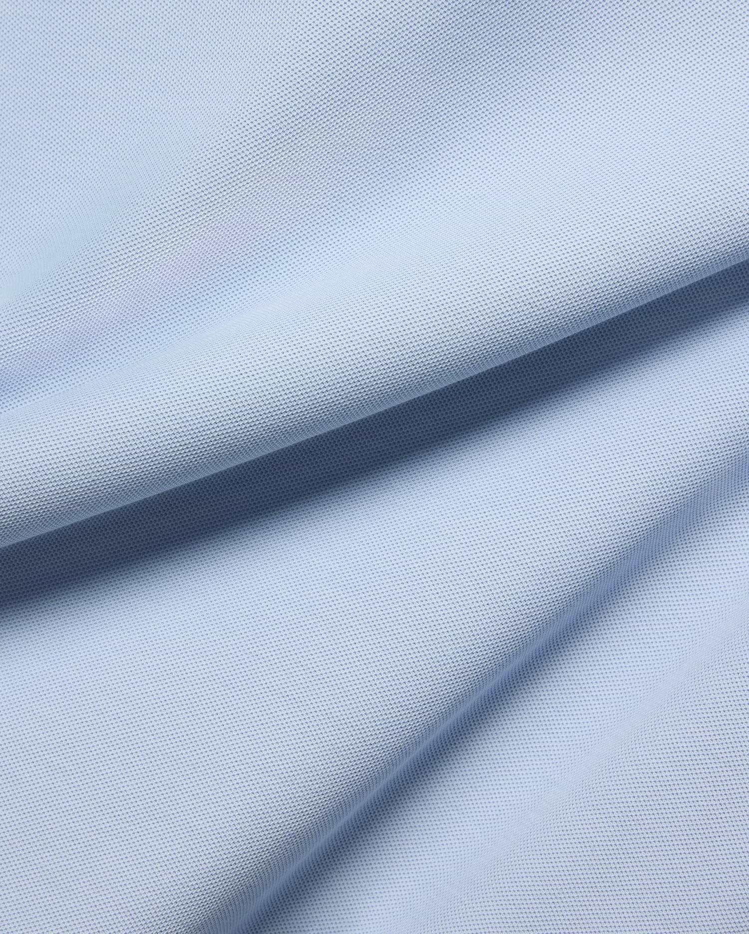 MENS TAYLOR PIQUE TEE in a serene light blue, highlighting the premium, breathable pique fabric with its distinctive textured weave and soft, flowing folds.