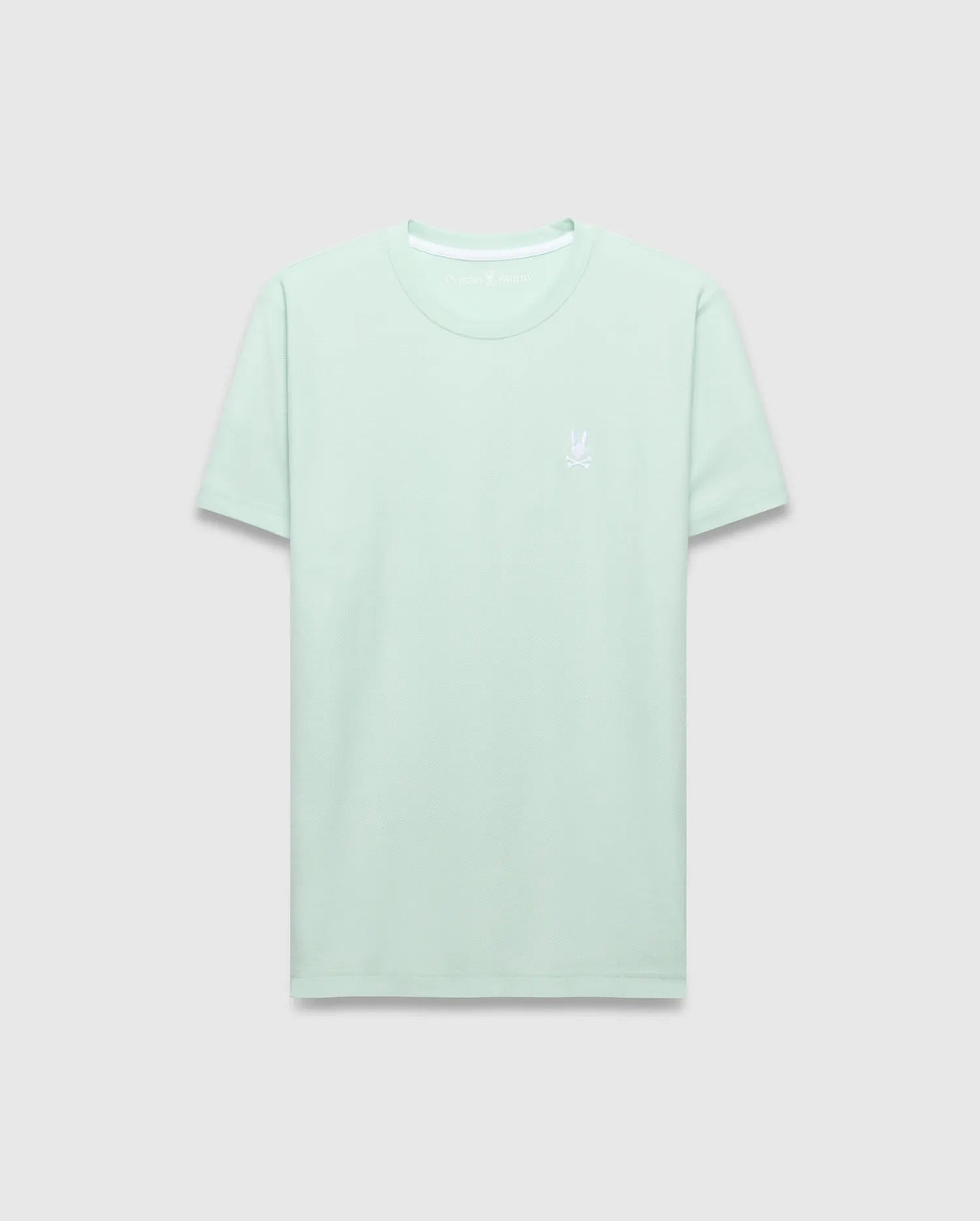 Mens Taylor Pique Tee, a classic fit light mint green pique knit t-shirt with a small white embroidered Psycho Bunny skull logo on the left chest and white neck trim.