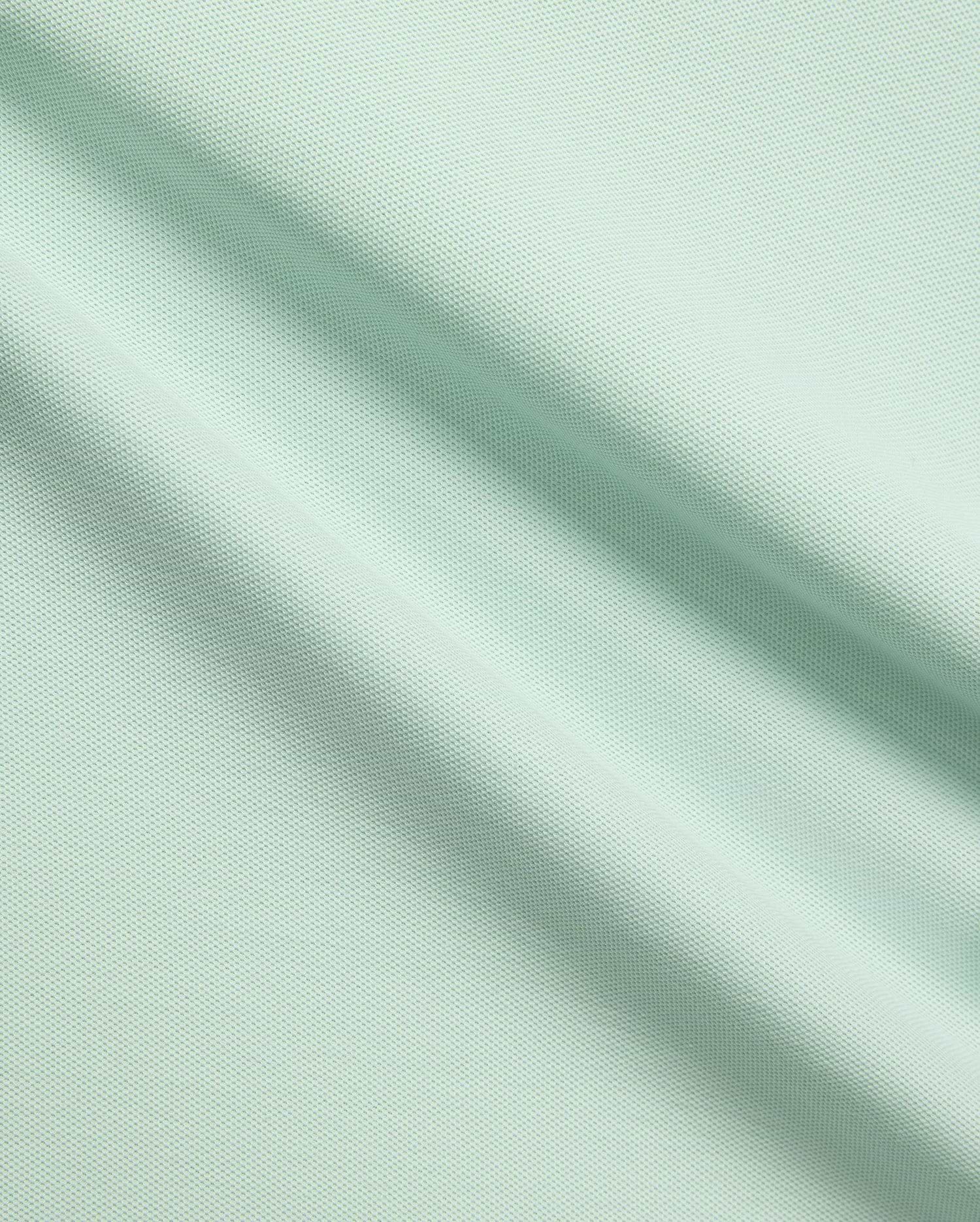 Mens Taylor Pique Tee in a vibrant light mint green, crafted from premium, breathable pique fabric, embodying Psycho Bunny's refined streetwear aesthetic for elevated casual style.
