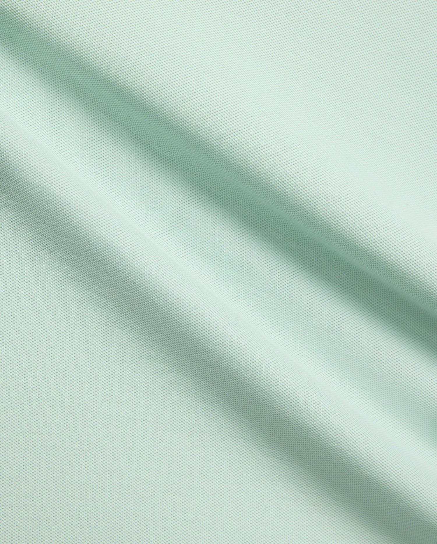 Mens Taylor Pique Tee in a vibrant light mint green, crafted from premium, breathable pique fabric, embodying Psycho Bunny's refined streetwear aesthetic for elevated casual style.