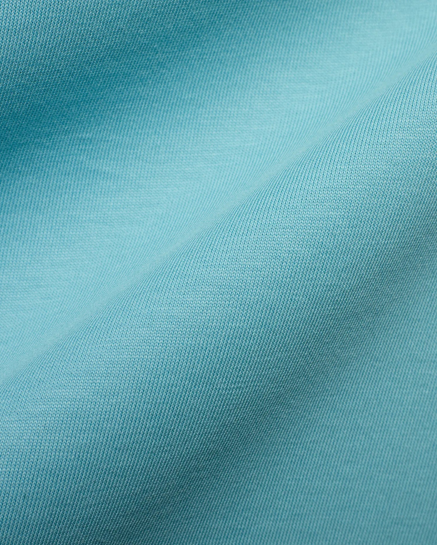 Men's Alfie Back Graphic Tee featuring a rich, vibrant turquoise soft jersey knit fabric with a finely woven, subtle diagonal texture, characteristic of premium Psycho Bunny apparel. (6)