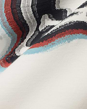 Men's Klaus Jacquard Tee featuring a cream jersey knit base with a bold jacquard pattern of black, white, red, and light blue wavy stripes. (6)