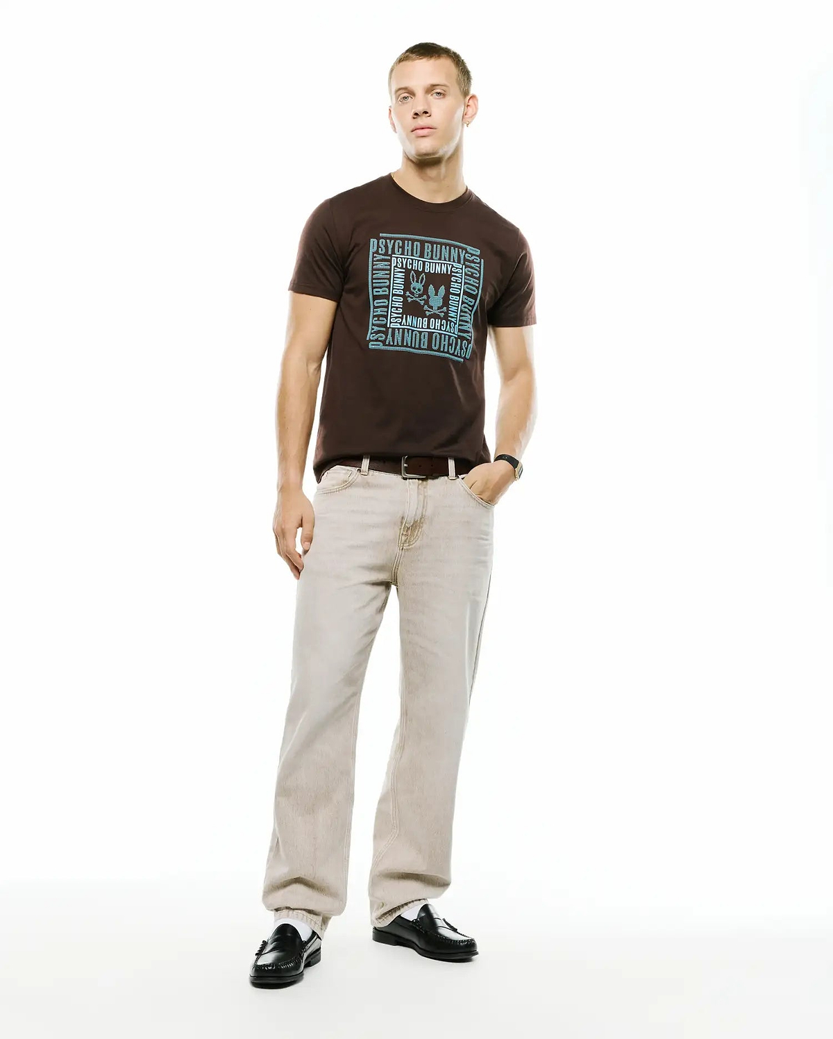 Men's Raj Wordmark Graphic Tee, a classic fit brown jersey t-shirt with a large light blue chest graphic featuring a square frame of repeating Psycho Bunny wordmark and the iconic bunny skull logo. (4)