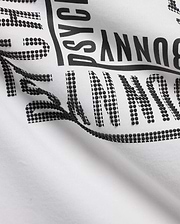 White Men's Raj Wordmark Graphic Tee in jersey knit, featuring a large black Psycho Bunny wordmark with a unique textured design where some letters are solid and others are raised black dots. (7)