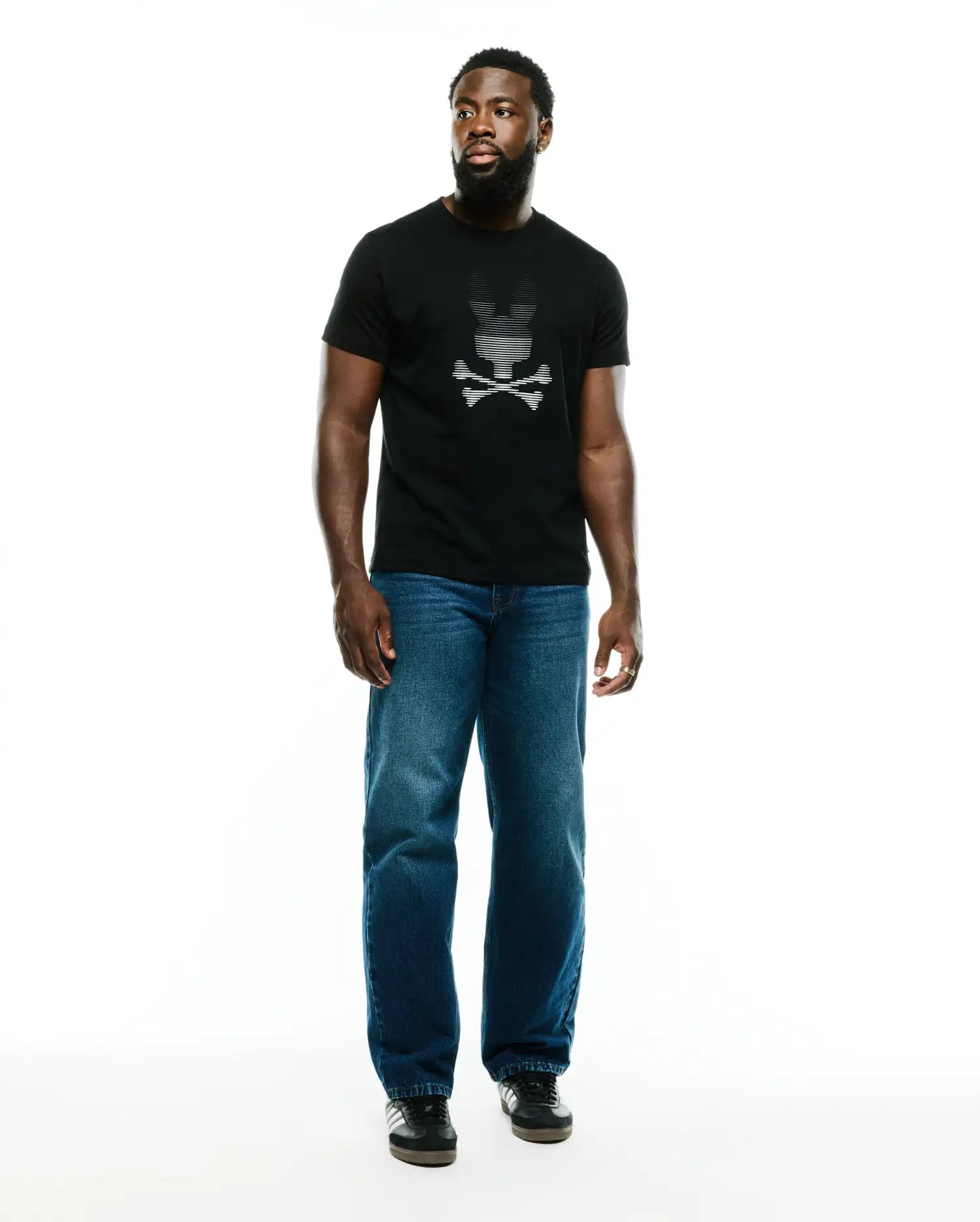 Men's Slade Bunny Graphic Tee, a classic fit black jersey t-shirt with a prominent, central white striped Psycho Bunny skull and crossbones graphic on the chest, embodying refined streetwear style. (5)
