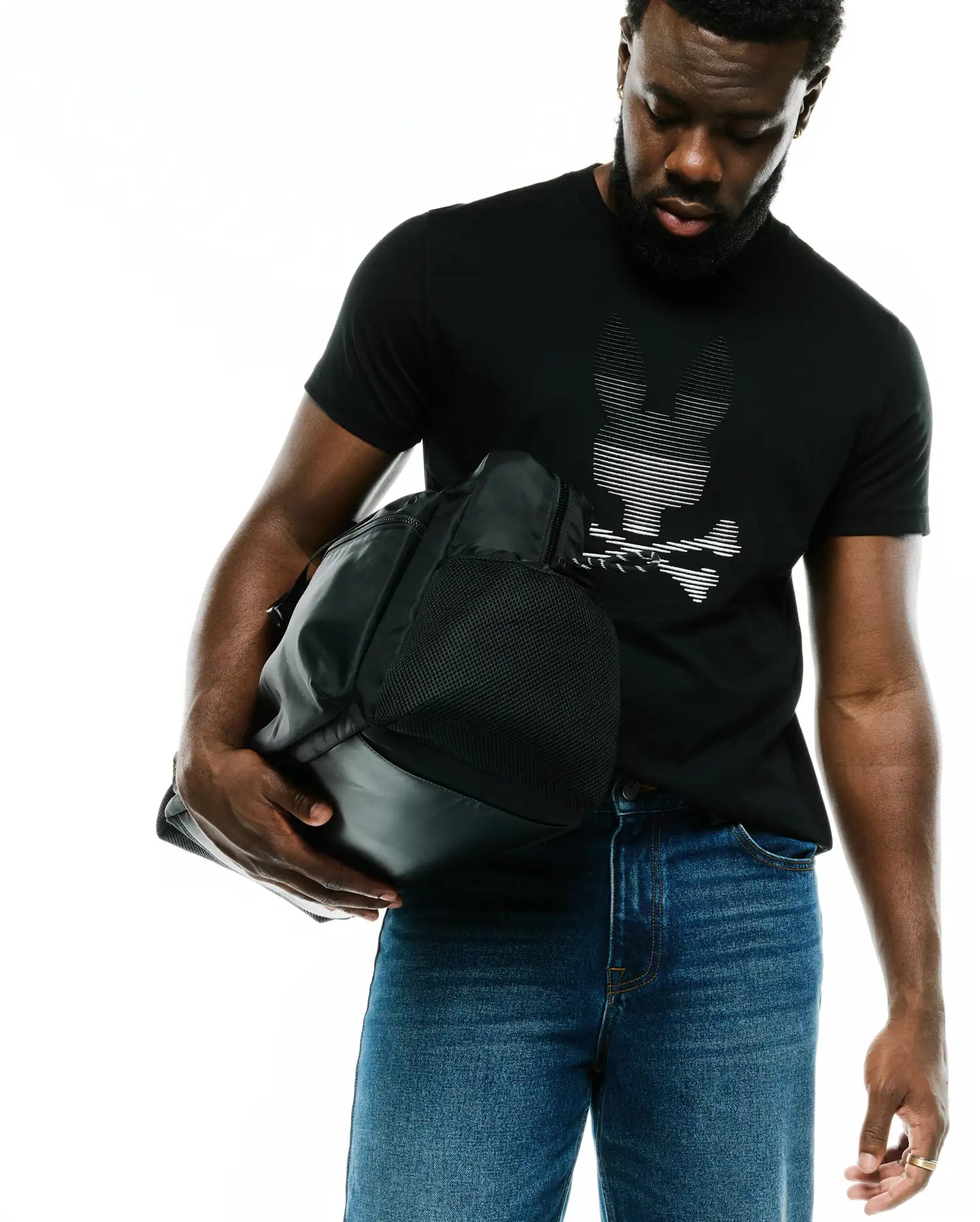 Men's Slade Bunny Graphic Tee, a premium classic fit black jersey t-shirt with a large, striking white horizontal-striped Psycho Bunny skull logo graphic on the chest. (4)