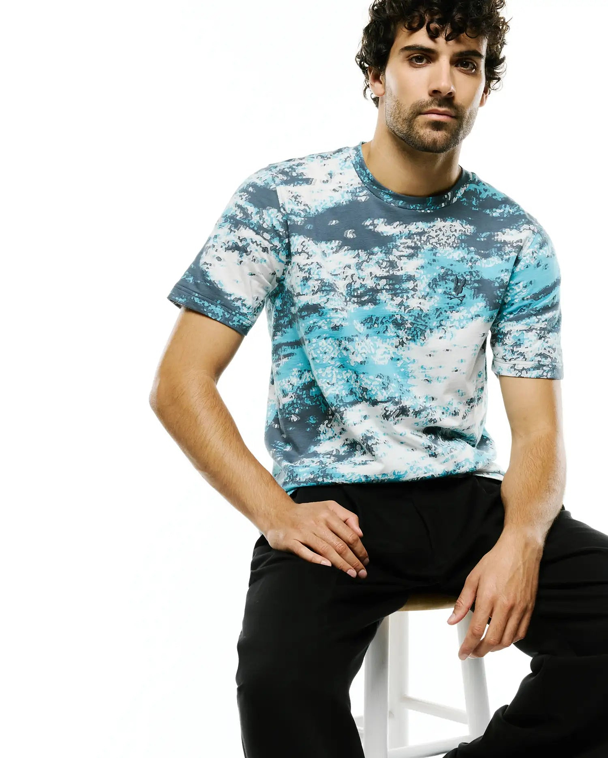 Men's Alfie All-Over Jacquard Tee featuring a classic fit, soft jersey knit, and an abstract blue, teal, and white digital camo pattern with a small embroidered Psycho Bunny skull logo on the left chest. (1)