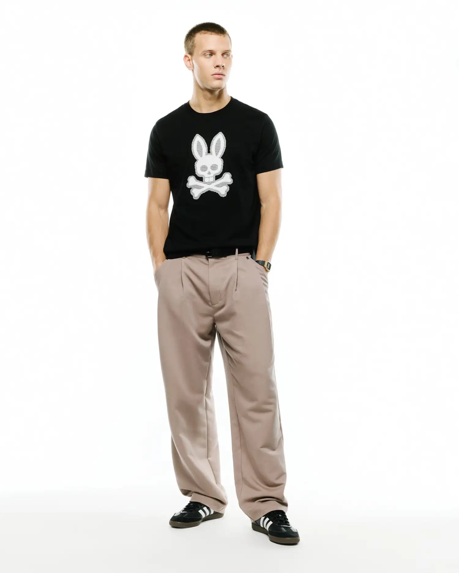 Men's Samson Graphic Tee, a classic fit black jersey t-shirt featuring a large, textured white Psycho Bunny skull and crossbones graphic prominently centered on the chest. (5)