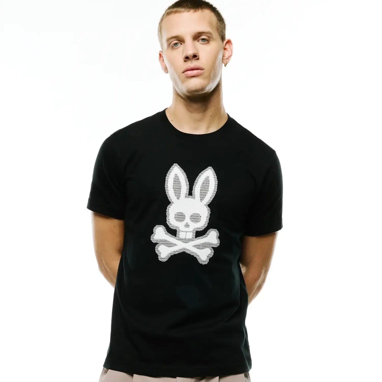 Men's Samson Graphic Tee, a classic fit black jersey t-shirt featuring a large, textured white Psycho Bunny skull and crossbones graphic prominently centered on the chest. (4)