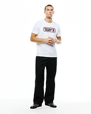 Men's Samson Wordmark Graphic Tee, a white classic fit jersey t-shirt featuring a prominent pink Psycho Bunny wordmark and skull logo graphic on the chest, paired with relaxed black wide-leg pants. (5)