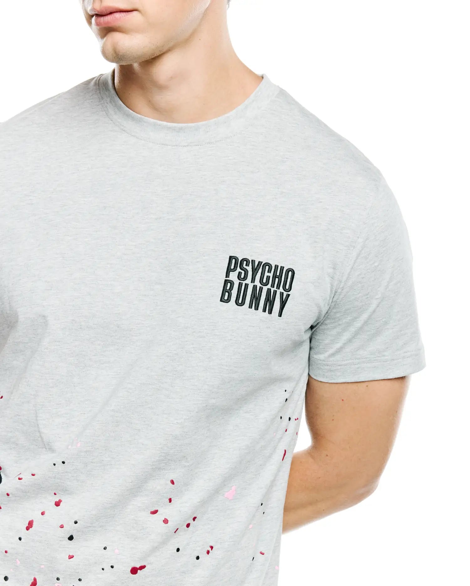 Mens Malcolm Graphic Tee, heather grey classic fit jersey t-shirt with small black Psycho Bunny text logo on left chest and vibrant black, red, and pink paint splatter graphic. (3)