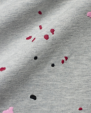 Mens Malcolm Graphic Tee, a heather grey jersey knit fabric detailed with embroidered red, black, and pink paint splatter graphics for a bold, refined streetwear look. (6)