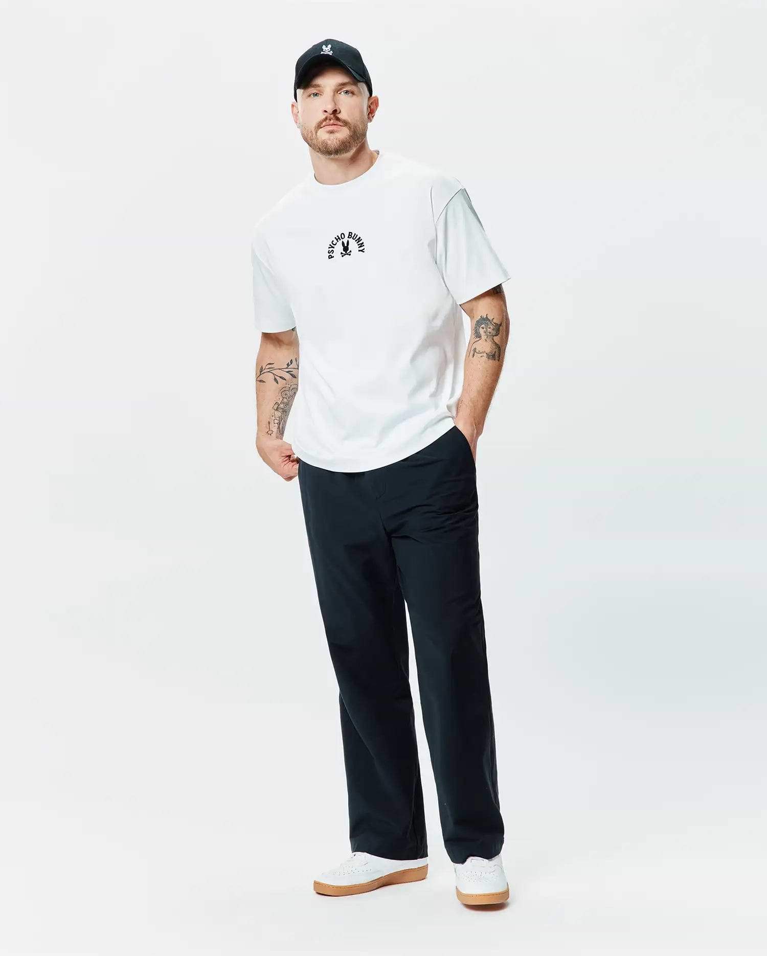 White Mens Stevie Relaxed Fit Tee in smooth jersey, featuring a small embroidered black Psycho Bunny arched text and iconic bunny skull logo on the center chest, offering a relaxed fit.