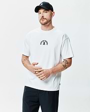 White Mens Stevie Relaxed Fit Tee in smooth jersey knit, featuring a black embroidered Psycho Bunny skull logo with arched PSYCHO BUNNY text on the center chest.