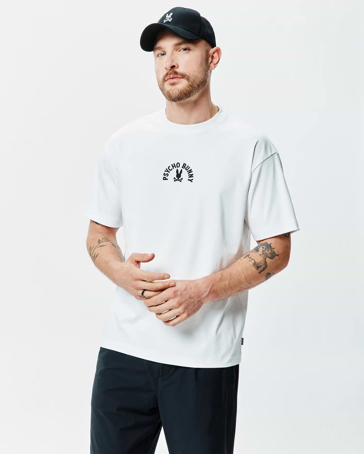 White Mens Stevie Relaxed Fit Tee in smooth jersey knit, featuring a black embroidered Psycho Bunny skull logo with arched PSYCHO BUNNY text on the center chest.