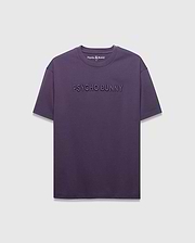MENS WINDCREST RELAXED FIT TEE in deep plum jersey, featuring a large tonal embossed PSYCHO BUNNY text across the chest and a small embroidered bunny skull logo at the back neck.
