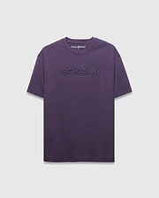 MENS WINDCREST RELAXED FIT TEE in deep plum jersey, featuring a large tonal embossed PSYCHO BUNNY text across the chest and a small embroidered bunny skull logo at the back neck.